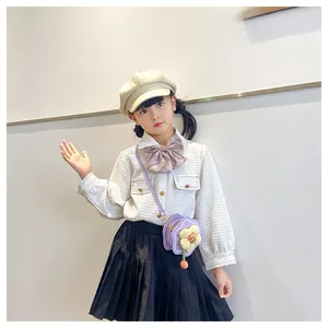 Detail of cute flower shaped purple crossbody bag paired with girls preppy style uniform