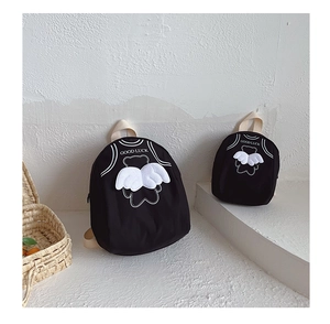 Detail showing the durable black fabric texture and 3D wing bear design on kids' backpacks