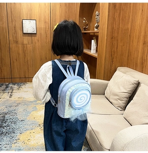 Girl's light blue lollipop backpack featuring sequins and tulle bow on child model