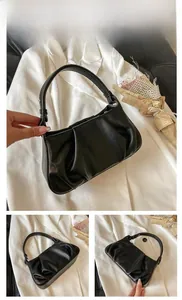 Detail view showing black ruched leather texture and shoulder strap of the cloud bag