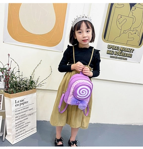 Detail of purple lollipop backpack with sequin bow worn by a young girl