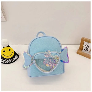 Detail of light blue glitter backpack with heart window and iridescent wings decoration