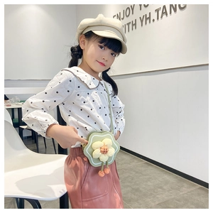 Detail view of a cute green floral crossbody bag for girls styled with a fashion outfit