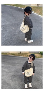 Detailed view of kids stylish messenger bag paired with striped autumn fashion set