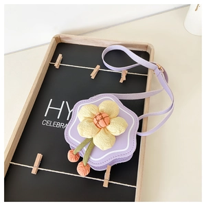 Detail of purple flower-shaped PU leather girl's crossbody bag with 3D yellow floral accent