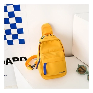 Detail of yellow nylon kids crossbody bag with front zipper and fashion text print