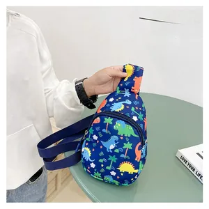 Detail of cartoon dinosaur print on navy blue canvas chest bag with adjustable strap