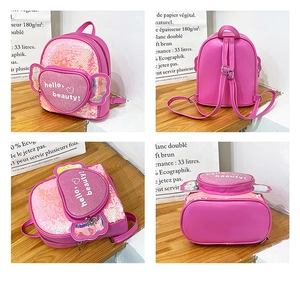 Detail view of pink sequin kids backpack with heart zipper pocket and cute wings decor