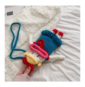 Close-up of handmade crochet Donald Duck style coin purse with intricate knit details