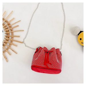 Detailed view of red rhinestone bucket bag with silver drawstring and metal chain
