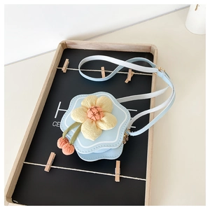 Detail of light blue floral kids crossbody bag with 3D flower and cherry charms