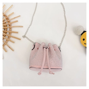 Macro detail of pink rhinestone bucket bag with silver chain strap and drawstring closure