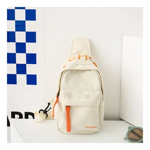 Detail view of cream canvas kids crossbody bag with orange fashion print and zipper straps