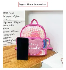 Detailed size comparison of pink sequin heart backpack next to a smartphone