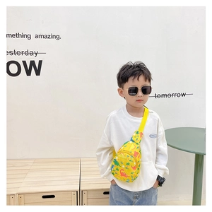 Detail of yellow canvas kids chest bag featuring colorful cartoon dinosaur prints