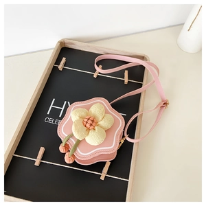 Detailed view of pink flower girl crossbody bag with plush petal and bead charms
