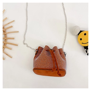 Close-up of brown suede bucket bag with sparkling silver rhinestones and chain strap