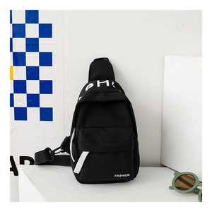 Detail of kids black canvas chest bag with adjustable strap and front zipper pocket