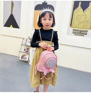 Toddler girl wearing pink glitter backpack with a 3D lollipop and tulle bow detail