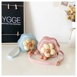 Detail view of mini flower shoulder bags for girls with 3D floral accents and PU leather strap