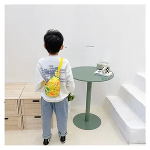 Close-up of kids yellow canvas chest bag with colorful dinosaur prints for boys