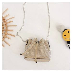 Detail of mini rhinestone bucket bag with silver chain strap and drawstring closure