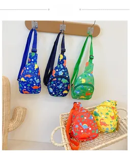 Detailed view of kids cartoon dinosaur chest bags in five bright colors on wooden hooks
