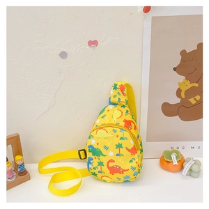 Detail of cute yellow kids crossbody bag with cartoon dinosaur print and adjustable strap
