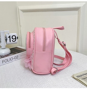 Pink sequin backpack for girls featuring tulle accents and zipper pockets in close detail