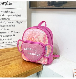 Detailed view of pink sequin backpack with heart pocket and hello beauty lettering