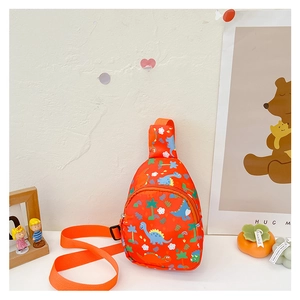 Side view of orange canvas kid's crossbody bag with colorful cartoon dinosaur prints