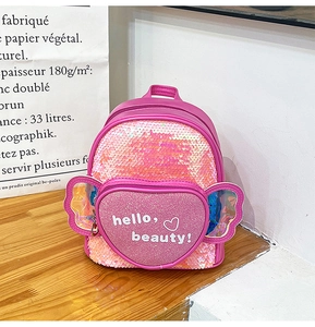 Detail of pink sequin kids backpack with iridescent wings and heart pocket