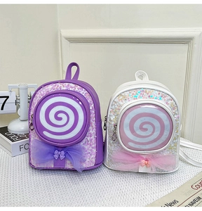 Close-up of glitter girls backpack featuring sequin lollipop design and mesh bow detail