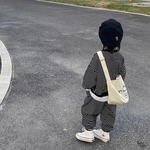 Boy's casual black and white striped tracksuit with canvas crossbody bag and cap