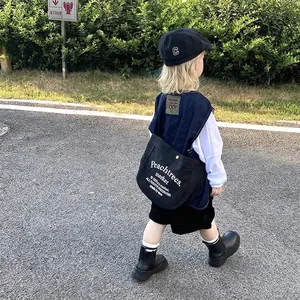 Cool kids canvas messenger bag in black with letter print and large capacity for travel