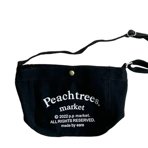 Minimalist black canvas crossbody bag for boys featuring white lettering and brass snap