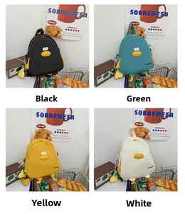 Detail view of cute cartoon duck backpacks in black, green, yellow, and white colors