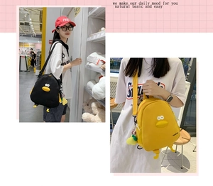 Detail of cute duck backpack with 3D eyes and feet featuring adjustable straps and charms