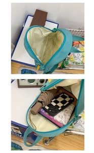 Detailed view of the spacious interior of a teal canvas backpack with daily items