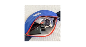 Internal view of blue nylon kids waist bag with orange zipper and spacious compartment