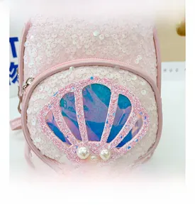 Detail showing pink sequin fabric with laser shell element and pearl accents on kids bag