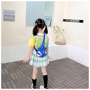 Rear view of child wearing the blue shark crossbody chest bag with adjustable strap