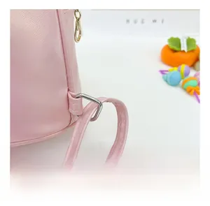 Detail of pink faux leather toddler backpack showing silver D-ring and stitching