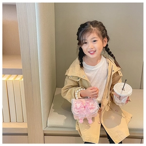 Pink sequin girl bag with pearl handle and mesh bow detail shown on a child model