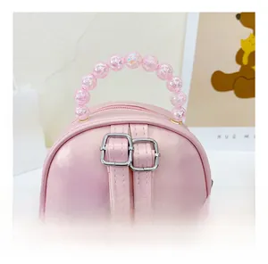 Pink toddler backpack featuring adjustable straps and a colorful beaded top handle