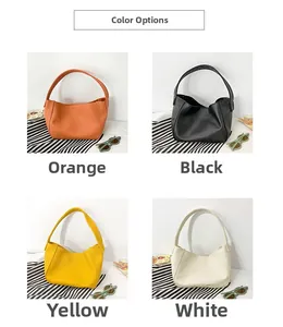 Detail view of mini children's dumpling bags in orange, black, yellow, and white PU leather