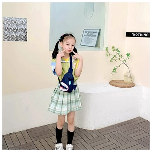 Detailed view of kids cartoon shark crossbody bag in navy blue canvas on a child model