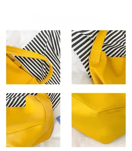 Detail view of yellow lychee texture leather stitching and shoulder strap on kids bag