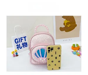 Mini pink sequin backpack for girls size comparison next to a smartphone