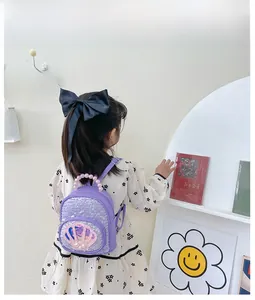 Detail of purple sequin toddler backpack with shell decor and elegant pearl handle